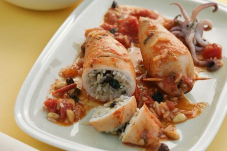 Squid, calamari, stuffed with rice, pine nuts, and raisins.