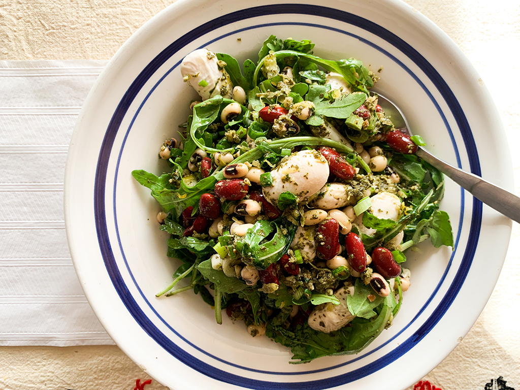 Greek salad with giant beans and grape leaf pest
